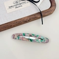 Close-up of vintage acetate hair clip with marble texture in green and pink tones - Peacock Green