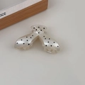 Close-up of large hair claw clip featuring black polka dots on cream acetate surface - Creamy White V-Shaped Style