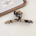 Close-up of tortoise shell pattern acetate hair claw with gold Creation France logo - Style A Light Tortoiseshell