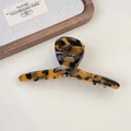 Detailed close-up of tortoise shell pattern acetate hair claw clip with gold lettering - Style A Deep Tortoiseshell