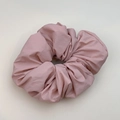 Pink oversized pleated fabric scrunchie with matte finish and voluminous layers - Pink