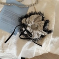 Close-up of lace-edged striped scrunchie with satin bow and pearl detail - Striped Lace Scrunchie