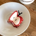 Detailed macro view of a red apple slice hair claw clip inside a white ceramic bowl - Large Apple Shape Hair Claw