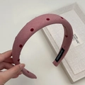 Detail showing dusty pink sponge headband with red polka dots and handmade label - Wide Style / Pink