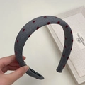 Detail of grey knitted headband with red hearts and handmade woven inner label - Wide Style / Gray
