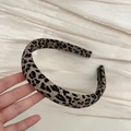 Close-up of leopard print fabric headband featuring a black handmade label detail - Light Leopard Headband (2cm)