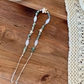 Detail of bohemian starfish hair tie with natural turquoise stones on a rustic wood background - Style B