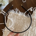 Minimalist black PU leather headband with elegant gold metal tips on a wooden surface - Black