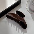 Detailed view of glossy dark brown acetate hair claw clip with strong interlaced teeth - Semicircle Arc