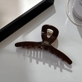Detail of amber acetate hair claw clip with gold France Handmade lettering and strong metal spring - Medium Cross