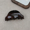 Detailed close-up of dark brown tortoiseshell acetate hair claw with golden La France logo - Chocolate Brown