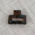 Detail of tortoise shell acetate claw clip with rectangle hollow design and gold logo - Blue Brown Gradient
