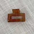 Detailed close-up of amber tortoiseshell claw clip with FRANCE Handmade gold lettering - Milk Coffee