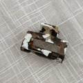 Detailed macro view of handmade French tortoiseshell acetate rectangle hair claw clip - Coffee & White