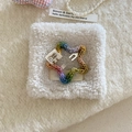 Detail of a handmade rainbow knit star hair clip with cartoon rabbit cotton tag - Pentagram Style / Colorful