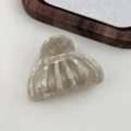 Macro detail of marble-textured acetate hair claw clip showing natural cloud patterns - Coffee White