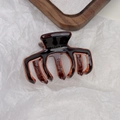 Detailed macro view of tortoiseshell acetate hair claw with gold France Handmade logo - Brown