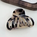 Detail view of medium French acetate hair claw clip with vintage tortoiseshell texture - Light Leopard