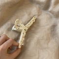 Detailed view of cream-colored acetate hair claw clip with multi-colored rhinestones - Crossed