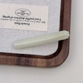 Detailed close-up of cream-white acetate hair clip with golden Barrette La France lettering - Light Green