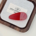 Detail view of red teardrop acetate hair clip with gold France Handmade logo on tray - Red