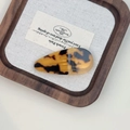 Detail of handmade acetate water drop hair clip with tortoiseshell texture on wooden tray - Leopard Print
