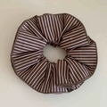 Classic brown and white striped fabric scrunchie with layered pleats on a neutral surface - Brown Stripes