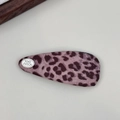 Detail view of pink leopard print fabric BB clip with silver logo and twill texture - Teardrop Knitted BB Clip / Leopard Pink Purple Waterdrop Snap Clip