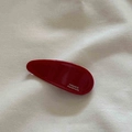 Close-up of handmade deep red acetate hair clip with France Handmade lettering detail - Red