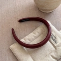 Close-up of handmade dark red leather sponge headband with a black hand made label - Burgundy Headband