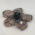 Detailed view of flower-shaped hair claw with retro plaid fabric and a large pearl accent - Orange Gray Striped Claw Clip