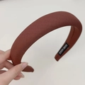 Close-up of brown ribbed sponge headband with handmade label showing fabric texture - Wide Style / Red