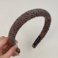 Detail of grey and orange knit headband showing textured weave and Handmade label - Blue Gray