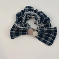 Detail of blue striped scrunchie with button accents, bow design and fringe edges - Navy Blue Striped Scrunchie