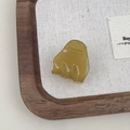 Detailed view of an amber yellow acetate hair claw clip with France golden logo lettering - Green