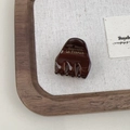 Close-up of a brown acetate hair claw featuring golden Barrette la France lettering - Dark Coffee