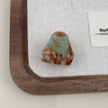 Close-up of mini acetate hair claw clip with marble texture and France gold logo - Mint Green Brown Gradient