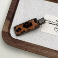 Macro detail of wave-edge leopard print hair clip on a minimalist wooden display - Coffee Leopard Square Style