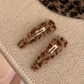 Set of two plush leopard print BB hair clips for Y2K style on a knit background - Waterdrop Style