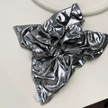 Detail of silver metallic scrunchie with shiny folded fabric and brand logo label - Silver Gray