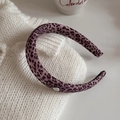 Elegant purple leopard print headband with a silk fabric texture and metal logo detail - Headband