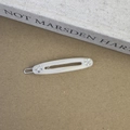 Detail of cream acetate oval hair clip with iridescent rhinestones and silver metal fastener - Mermaid Color