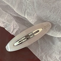 Close-up of pink acetic acid oval hair clip with Barrette La France engraving - Light Pink
