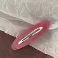 Detailed macro view of magenta acetate oval barrette clip with Barrette La France lettering - Jelly Rose Pink