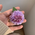Detail of purple fabric pompon mum hair clip showing realistic petals and green leaf - Purple
