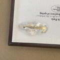 Detailed close-up of cloud-shaped acetate hair clip with gold foil and blue marble texture - Light Gray Blue
