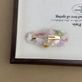 Detail of acetate cloud pattern hair clip with gold metal clasp on a canvas tray - Mixed Colors