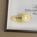 Detailed view of yellow acetic acid cloud hair clip with irregular wave design and metal grip - Yellow