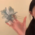 Close-up of a large blue gradient tulle flower hair pin with golden dual-prong forks - Blue