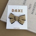 Close-up of handmade ribbed brown fabric bow hair clip with elegant black stitched edges - Brown Ribbed Texture Bow Hair Clip (No. 9)